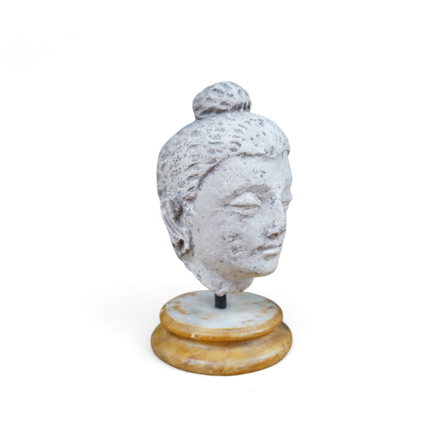 A stucco work head of Buddha, on marble stand, 21cm. Condition - fair